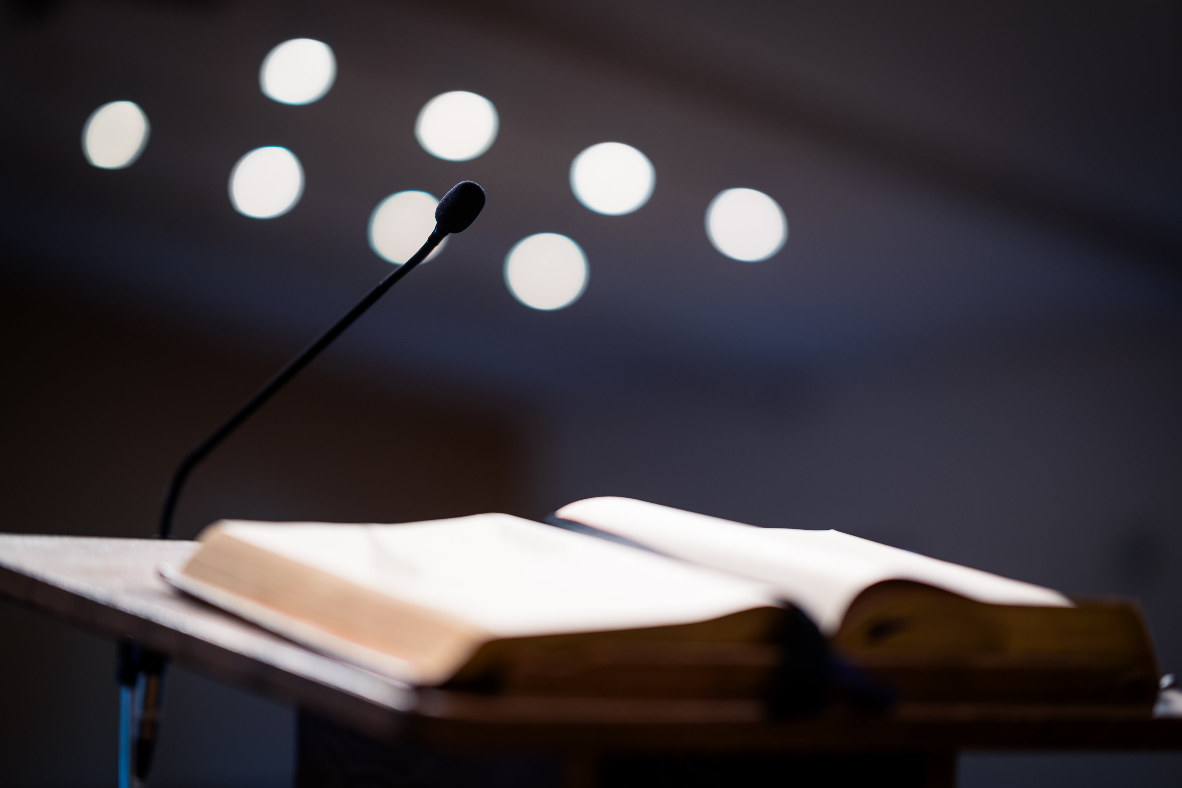 open bible on pulpit with microphone