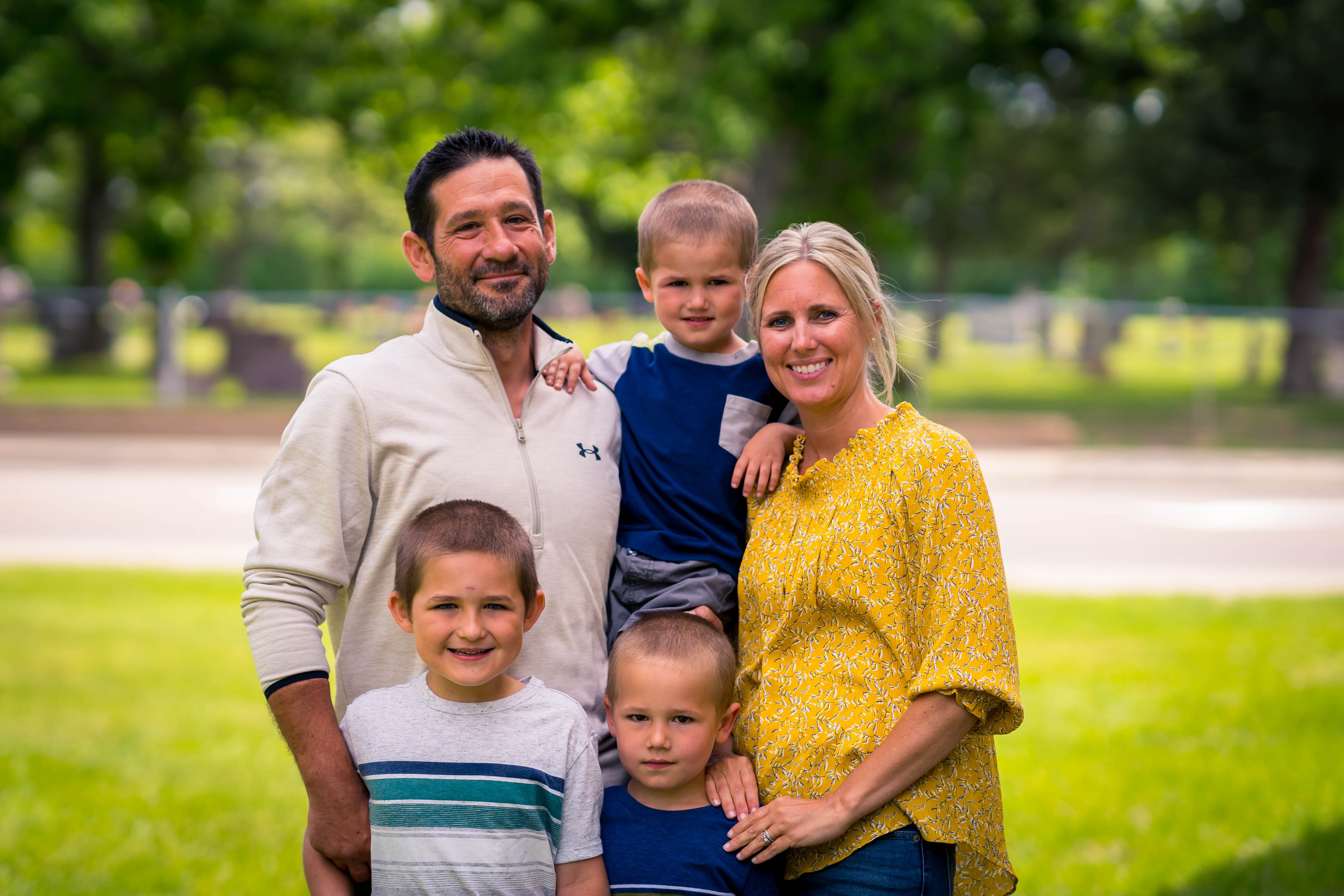 young man and woman with three young boys family photo